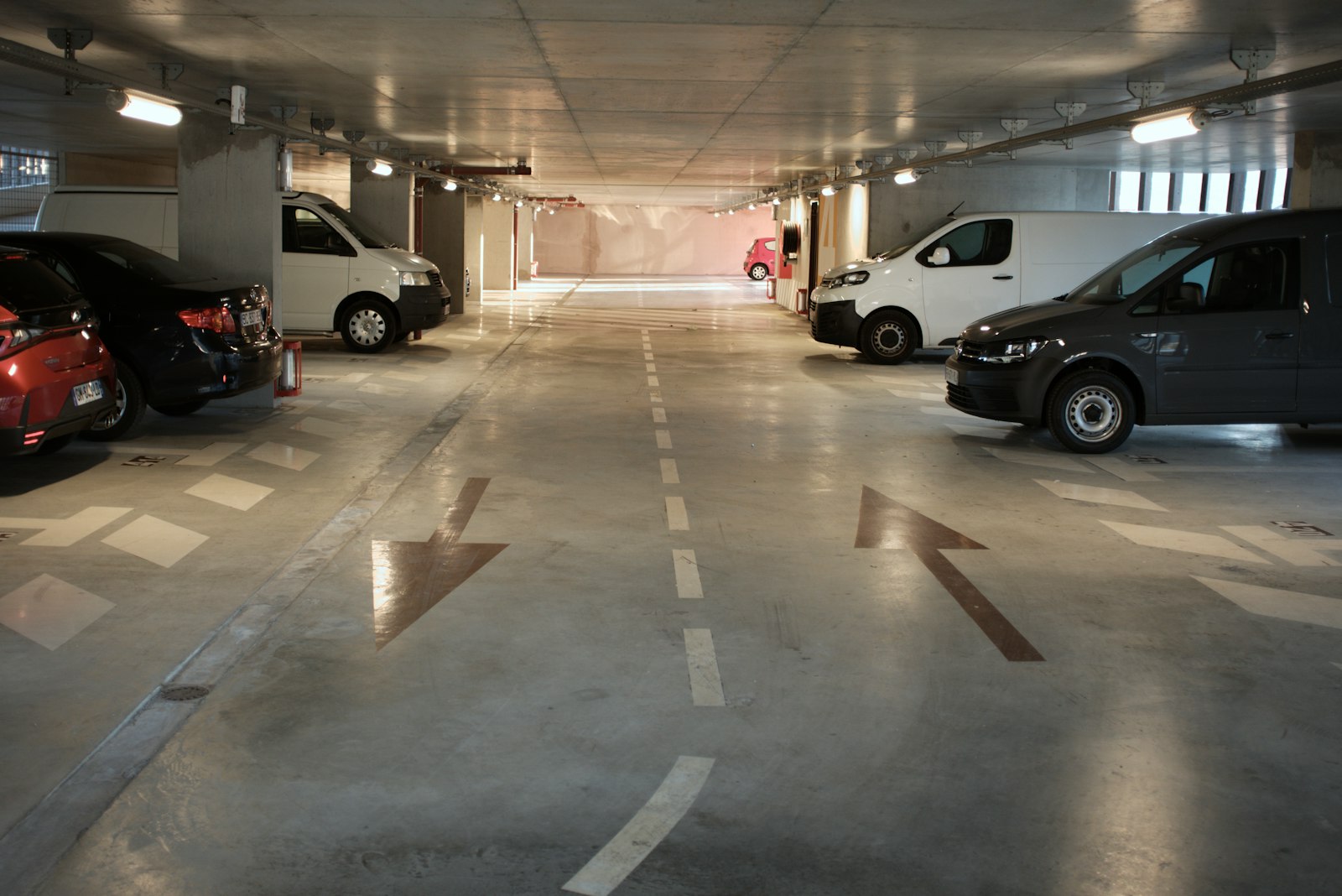 cars parked in a garage representing compact versus midsize rideshare choices