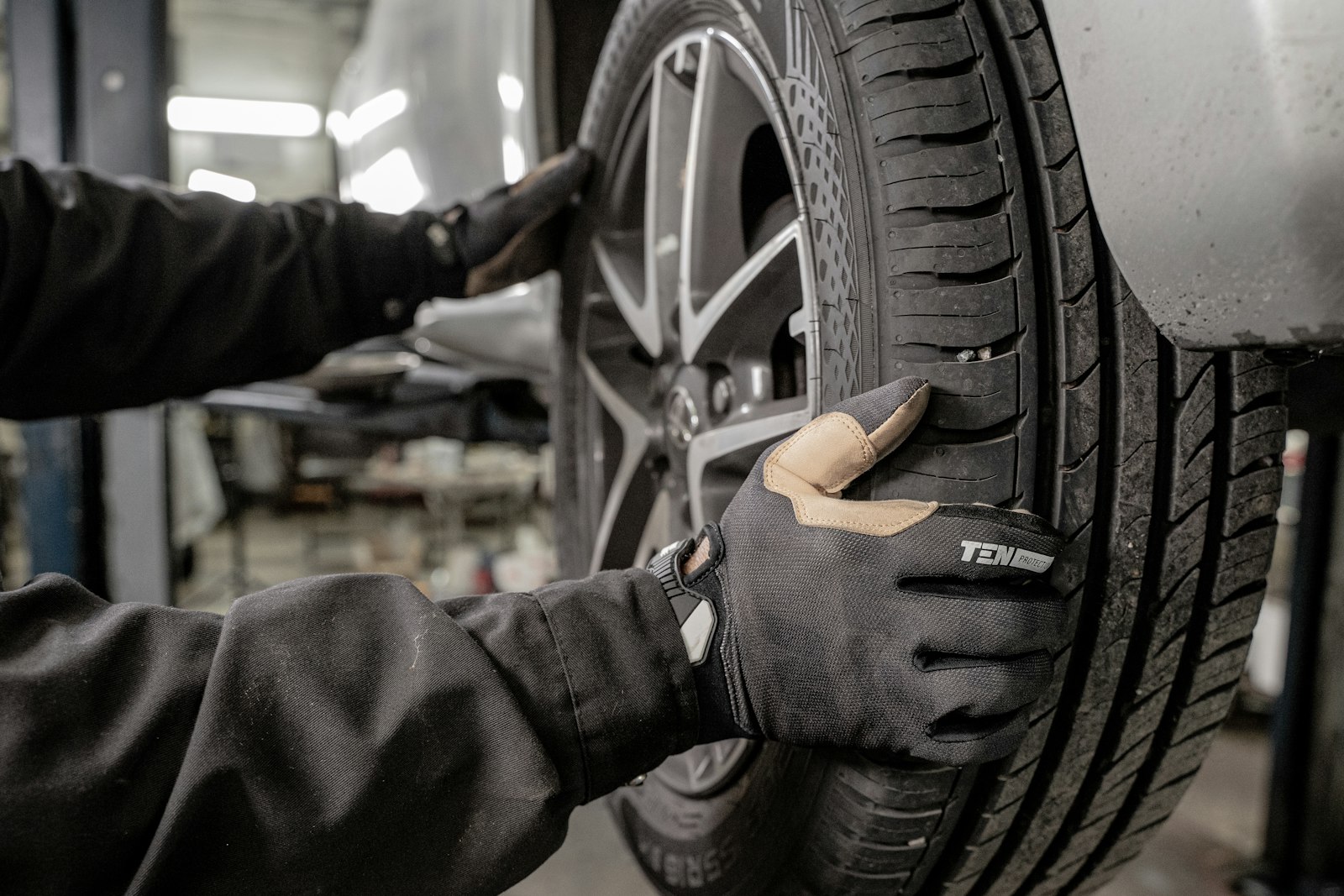 mechanic changing a tire during preventive maintenance on a working vehicle