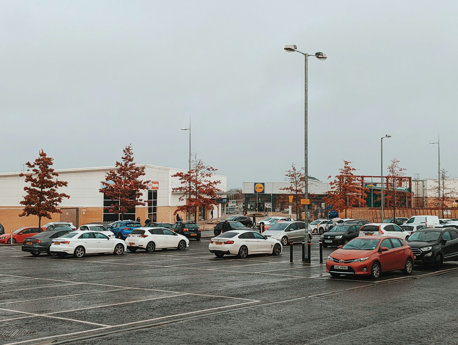 parking area with multiple vehicles representing sedan and minivan rental choices