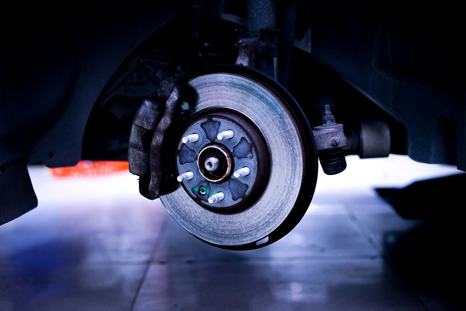 automotive suspension components representing alignment problems and tire wear