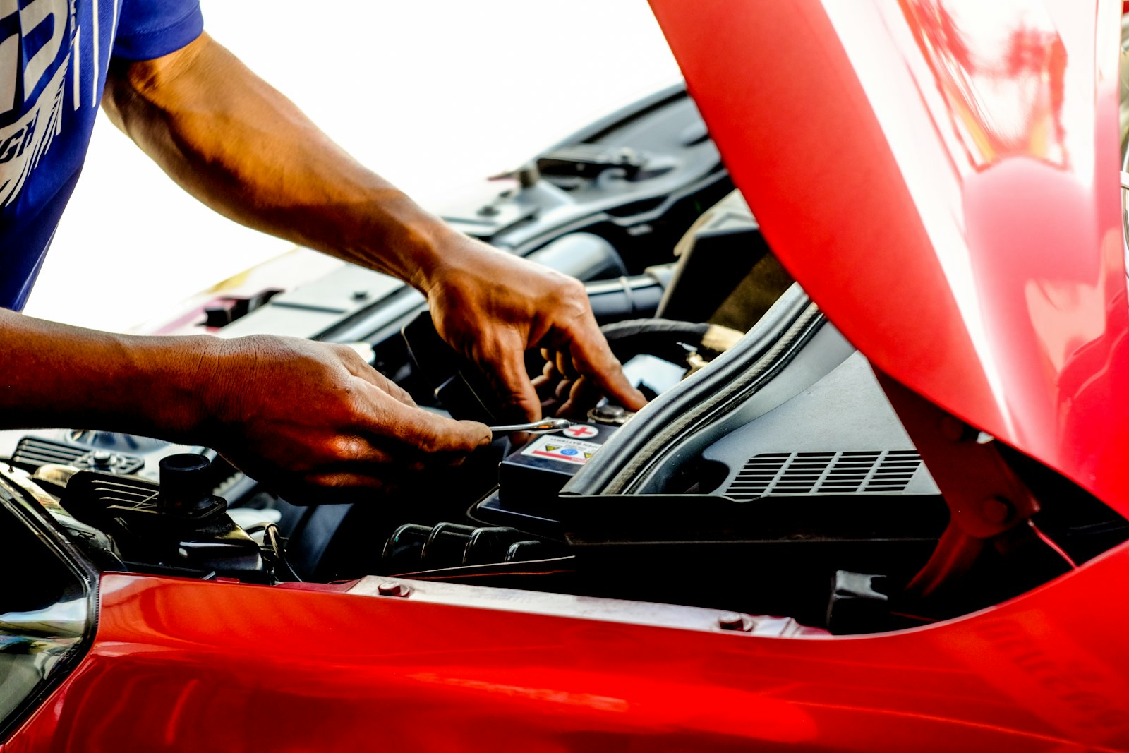 person working on a car during maintenance before a no-start problem